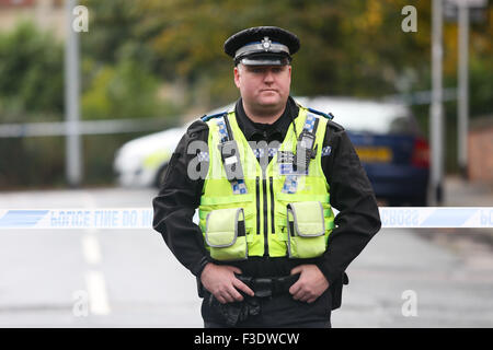 Police guard the scene of a murder in Leeds, West Yorkshire, on October 6th 2015. Police were called to Moorfield Avenue in Armley, Leeds, UK late last night. Officers searched the area and found a 27-year-old man in Back Moorfield Terrace. Although paramedics treated the man, he was pronounced dead at the scene. A 43-year-old man has been arrested on suspicion of murder and is currently in custody.  Ian Hinchliffe /Alamy Live News Stock Photo