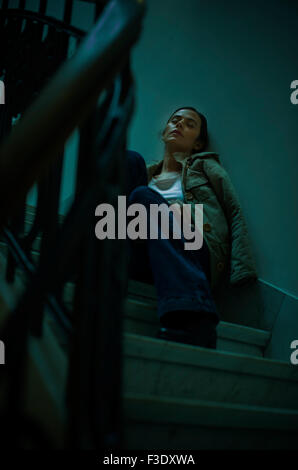 Woman sleeping on staircase Stock Photo