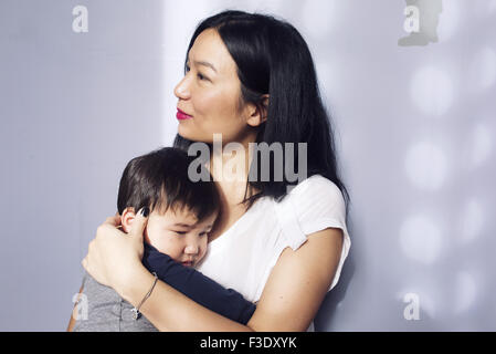 Mother embracing young son Stock Photo