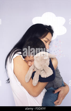 Mother embracing young son Stock Photo