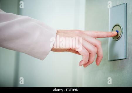 Pushing elevator call button Stock Photo