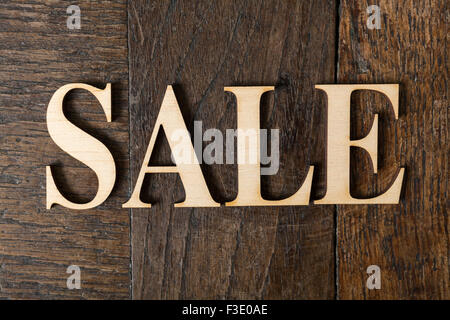 Wooden letters forming word SALE written on old vintage wooden plates Stock Photo