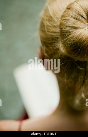 Woman reading, over the shoulder view Stock Photo