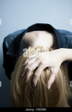 Hand caressing woman's blonde locks Stock Photo