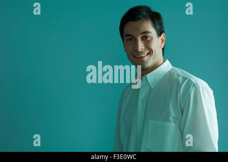 Man in button down shirt smiling at camera Stock Photo