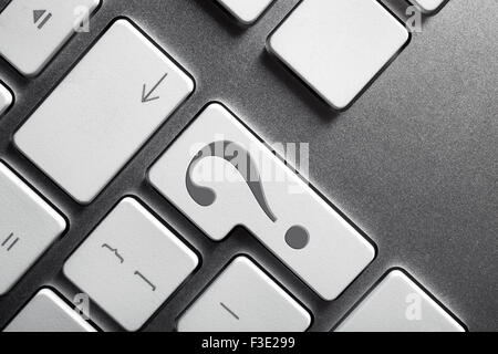 Close up of a keyboard with a big question mark featuring on Enter key Stock Photo