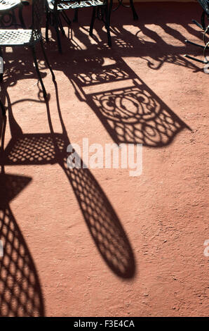 Long shadows of chairs cast in the bright sunlight on the island Republic of Cuba Stock Photo