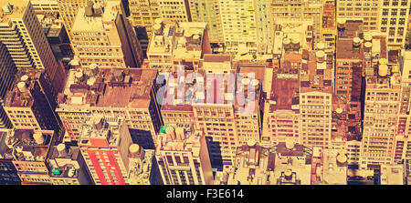 Retro filtered panoramic view of Manhattan roofs, New York, USA. Stock Photo