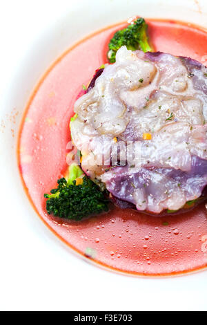 Fish fillet soup with tomato sauce and broccoli Stock Photo