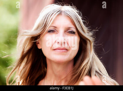 Portrait of a Middle-aged Woman with Blond Hair Looking Stock Photo