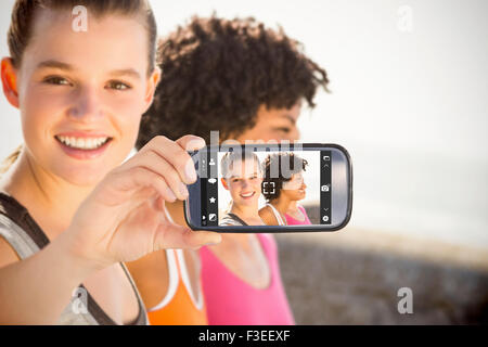 Composite image of hand holding smartphone showing Stock Photo