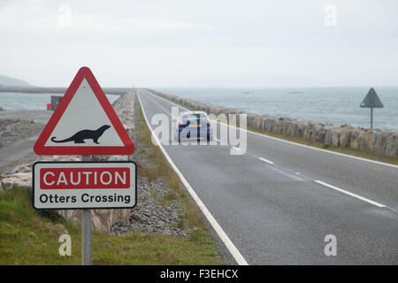 A caution Otters crossing sign on the start of the South Uist to Eriskay causeway, Outer Hebrides, Scotland. Stock Photo