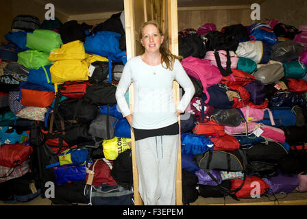 Co-founder of an appeal for donations to help refugees fleeing war torn Syria surrounded by some of the donated bags for... Stock Photo