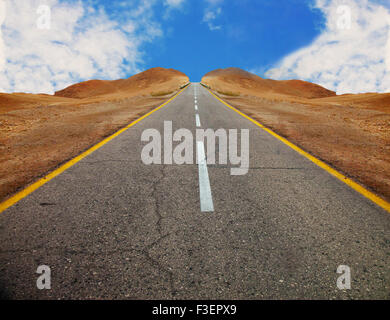 A fragment of old asphalt road between desert hills with symmetrical slopes before sunset Stock Photo