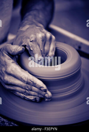 Old man hands working on pottery wheel Stock Photo