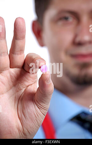 Male doctor showing a blue pill on the white background Stock Photo