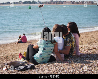 A group of young people taking selfie photographs on the beach Stock Photo
