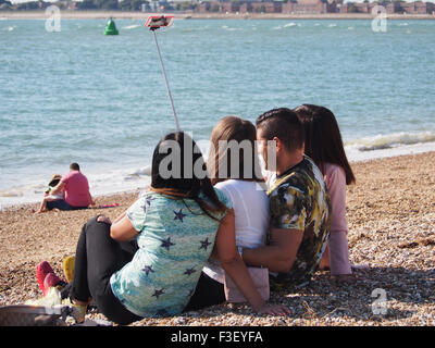 A group of young people taking selfie photographs on the beach Stock Photo