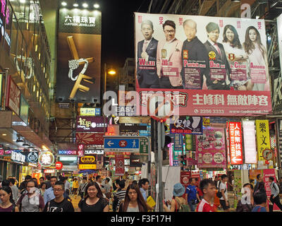 Busy shopping street crowded with shoppers in the Mong Kok district of Hong Kong at night Stock Photo