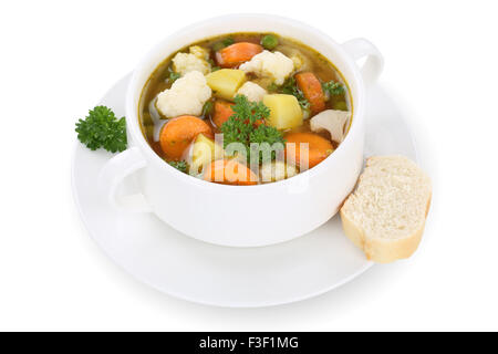 Vegetable soup meal with vegetables, potatoes, carrots and peas in bowl isolated on a white background Stock Photo