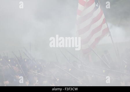Smoke-obscured Civil War reenactors and the Union flag at the 150th anniversary of the Battle of Gettysburg, June 28, 2013. Stock Photo