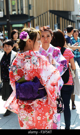 Young Japanese women dressed in colorful traditional Kimono dresses. Stock Photo