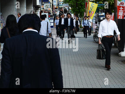 Busy sidewalks. After a long day at work people begin their long journey home. Stock Photo