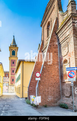 clothes hung out to dry on a drying rack in front of historic ruins in Italy Stock Photo