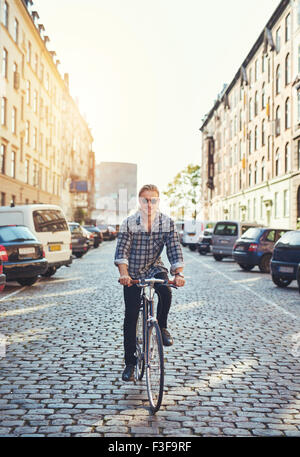 Man riding his bike through the city, Smiling at camera looking cool