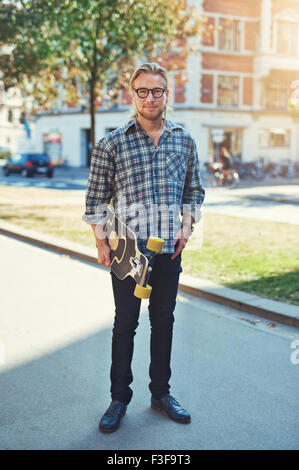 Hipster style portrait of young man. Stylish man with long blond hair Stock Photo