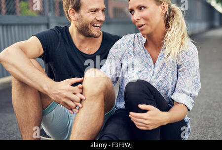 Couple having a good time while sitting on the ground Stock Photo