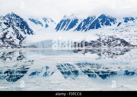 Monacobreen glacier, reflected in the water, Liefdefjorden, Spitzbergen, Norway Stock Photo
