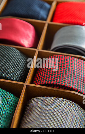 High contrast image of display of different patterns and colours of man ties in a shop or showroom.Shallow DOF Stock Photo