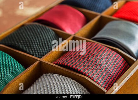 High contrast image of display of different patterns and colours of man ties in a shop or showroom.Shallow DOF Stock Photo