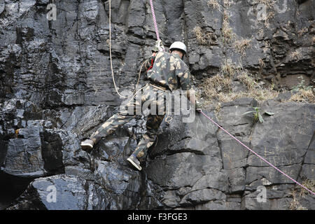 Commando obstacles training rock climbing at Amboli Ghat ; Amboli hill station ; Military school ; Amboli Sindhudurga Stock Photo