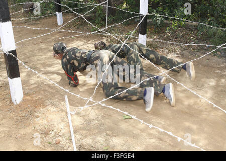 Commando obstacles training ; cadets crawling under the barbed wire ...