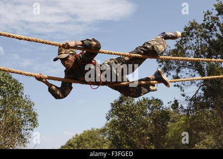 Commando Obstacles training ; cadet crossing the distance with Hand and ...