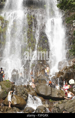 Popular waterfall of Amboli Ghat tourist bathing ; Sawantwadi to Amboli Hill station ; Maharashtra ; India Stock Photo