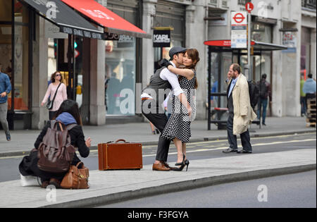 London, England, UK. Japanese couple (models) posing for a photographer in Regent Street Stock Photo
