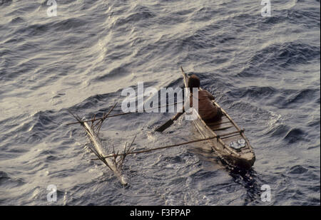 A Nicober boy on boat Nicober tribal life at Andaman and Nicobar Island ; India Stock Photo