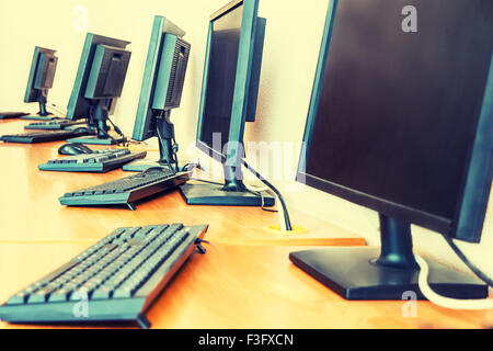 Desktop computers on the table in row, toned image, copy space Stock Photo