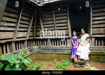Namboothiri girl and mother sitting in 175 years old Perumangatu Mana in Panjal ; Kerala ; India NO MR Stock Photo