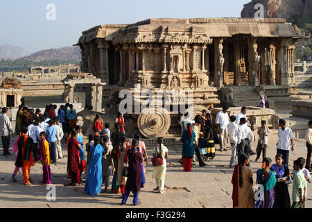 Students near stone chariot in Vijaya Vittala temple complex ; Hampi Vijayanagar ruins ; Karnataka ; India Stock Photo