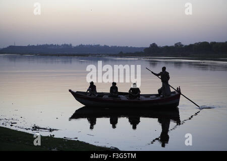 Man rowing boat in Yamuna River ; Agra ; Uttar Pradesh ; India Stock Photo