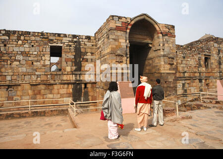 Tourists at Quwwat ul Islam mosque in Qutb Minar Complex built in 1311 ; Delhi Stock Photo