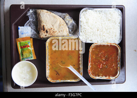 Chapatti Dal Rice Sabzi Pickle Curd salt of lunch served in Train ; Tamil Nadu; India Stock Photo