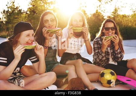 Teenage girls hanging out in a park on a summer evening Stock Photo