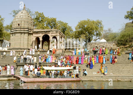 People performing puja on Peshwar Ghat on the bank of river Narmada at Maheshwar ; Madhya Pradesh ; India Stock Photo