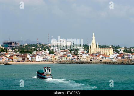 Our lady of ransom church ; hotels ; village houses ; ferry boat service and coast of Kanyakumari ; Tamil Nadu ; India Stock Photo