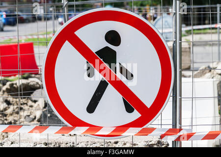 Entry prohibited road sign hanging on construction area border Stock Photo